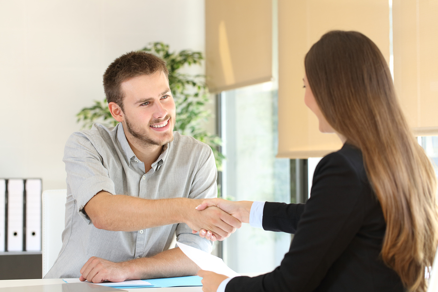 Happy employee and boss handshaking after a successful job interview at office