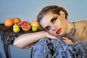 Beautiful Woman With Feathers And Fruit
